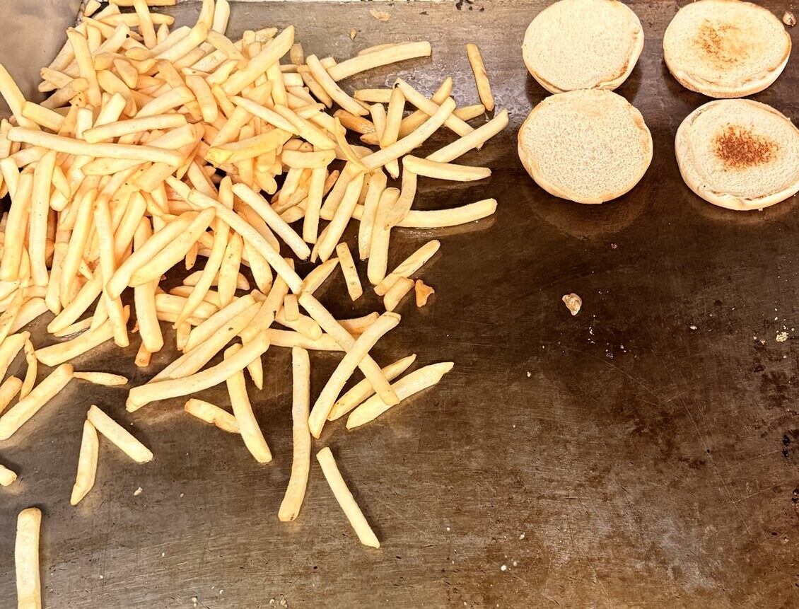 Fries and toasted buns on the Burger Cart griddle
