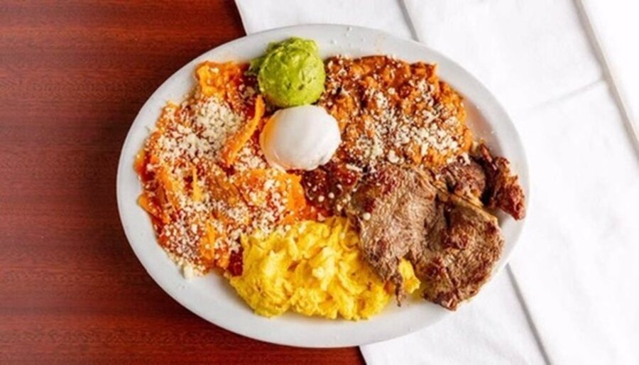 B&C chilaquiles topped with cotija, sour cream and guacamole, with eggs and carne asada