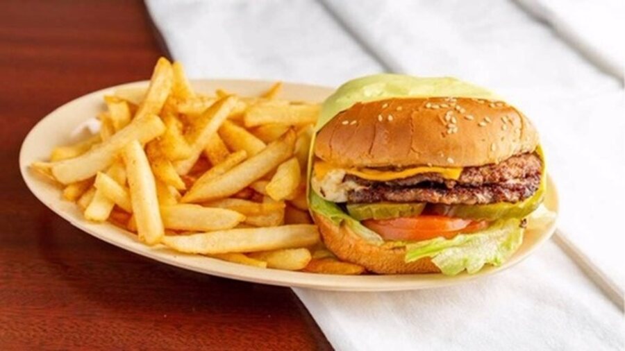 Double cheeseburger with lettuce, tomato and pickle, served with fries
