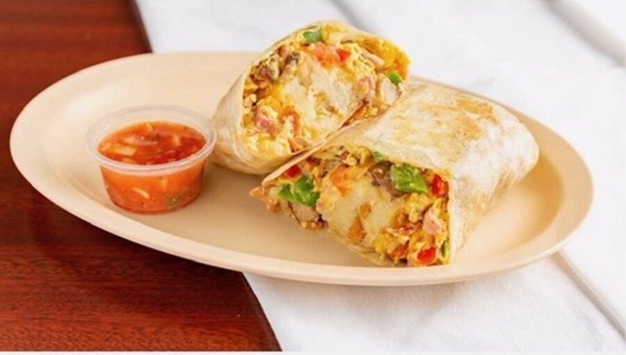Machaca burrito cut in half, with a side of salsa