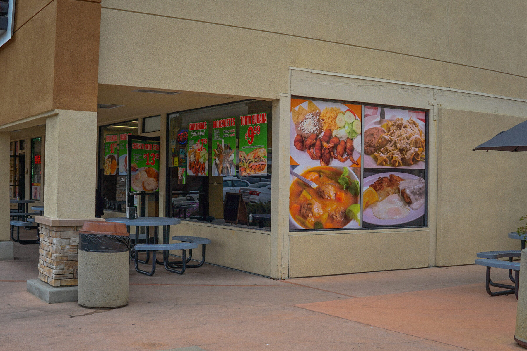 The B&C Burgers storefront on 1868 N Placentia Ave, with menu posters in the windows and patio tables outside